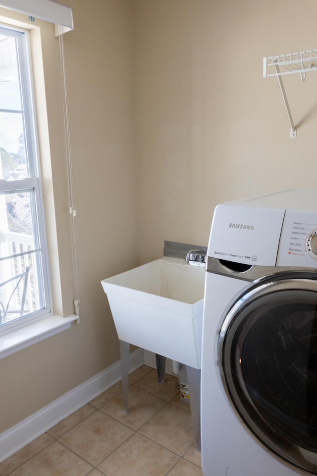 washroom featuring light tile patterned flooring and washer / dryer