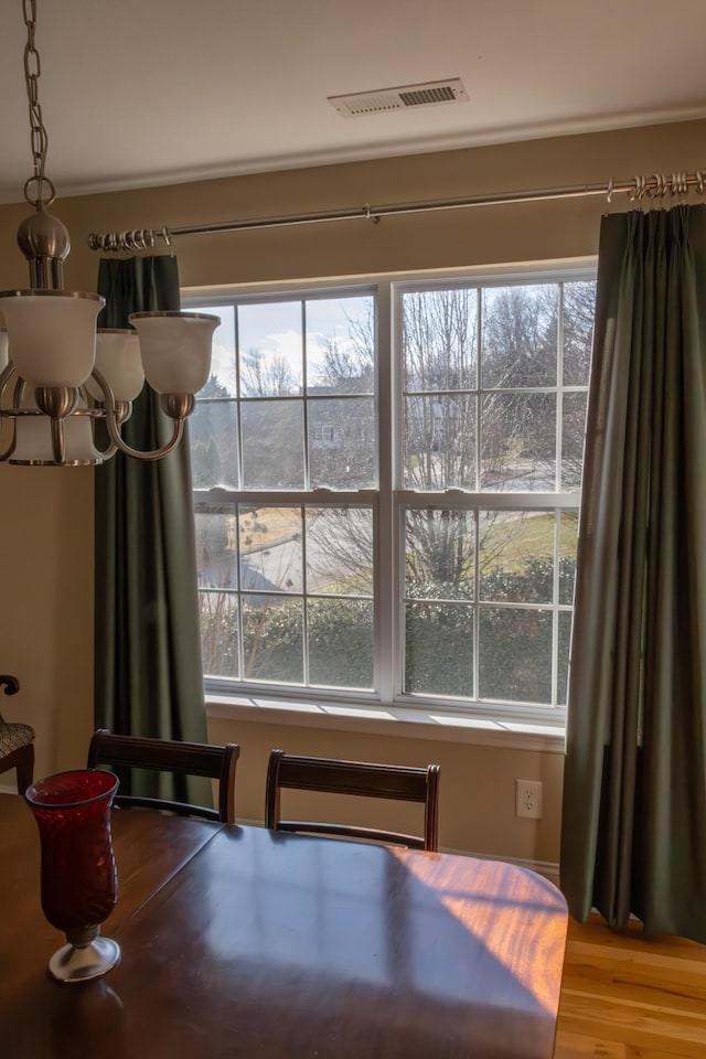 dining room featuring a chandelier and wood-type flooring