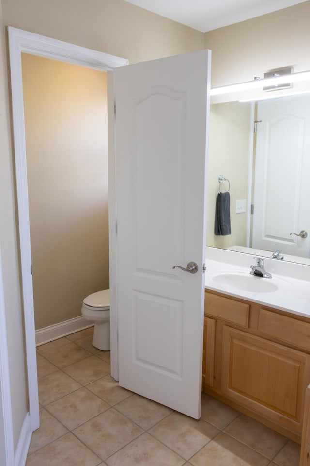 bathroom with tile patterned floors, vanity, and toilet