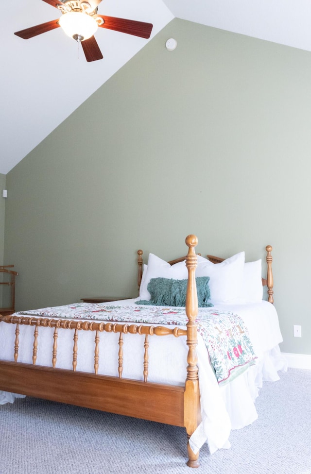 carpeted bedroom with ceiling fan and vaulted ceiling