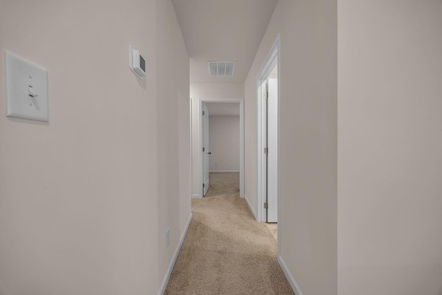 hall featuring light colored carpet