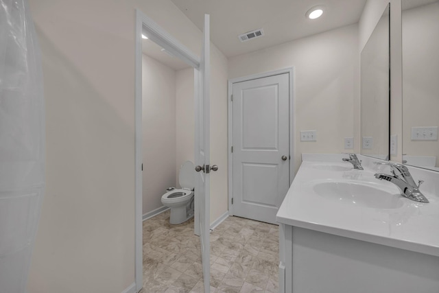 bathroom with vanity and toilet