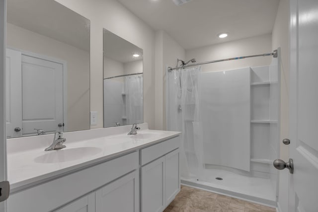 bathroom with vanity and walk in shower