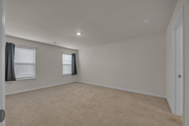 unfurnished room with light carpet