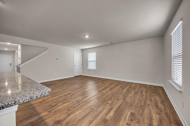 unfurnished living room featuring dark wood-type flooring