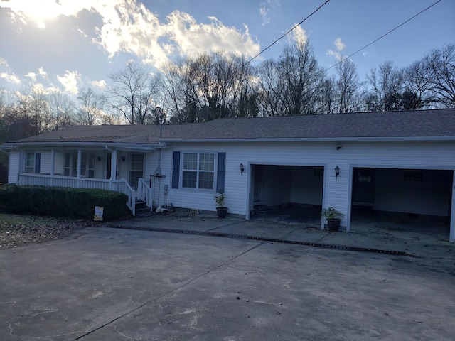 single story home with covered porch and a garage