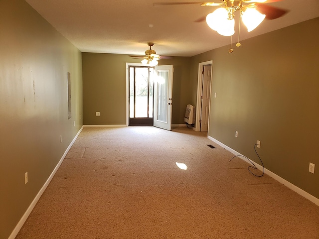 empty room featuring carpet and ceiling fan