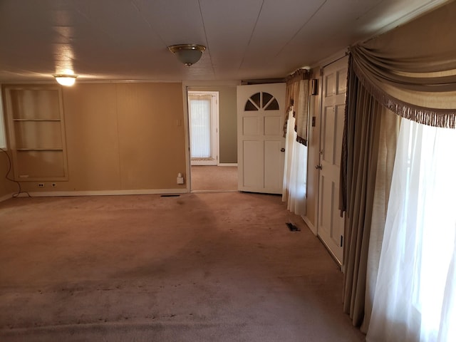 unfurnished room with light colored carpet