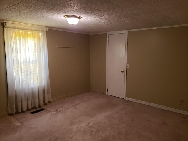 carpeted empty room with ornamental molding