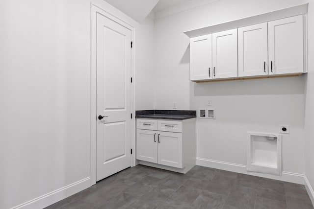 laundry room with baseboards, washer hookup, cabinet space, and hookup for an electric dryer