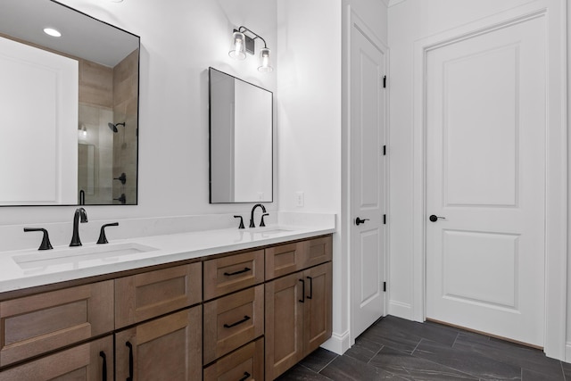 bathroom with double vanity, a sink, and a shower stall