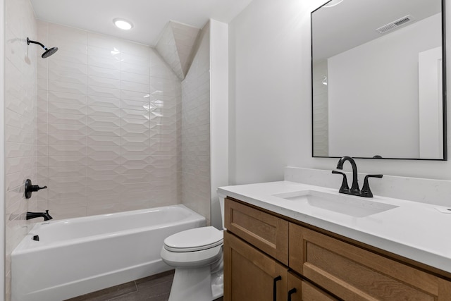 full bathroom featuring visible vents, toilet, wood finished floors, bathtub / shower combination, and vanity