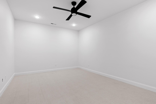 carpeted spare room with visible vents, baseboards, a ceiling fan, and recessed lighting