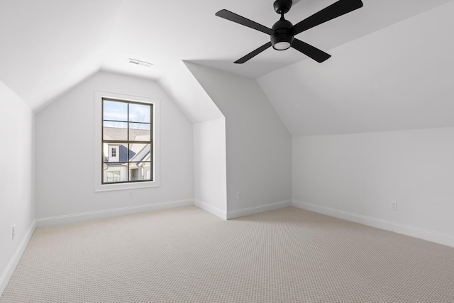 bonus room with baseboards and light colored carpet