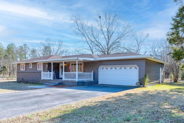 ranch-style house featuring covered porch and a garage