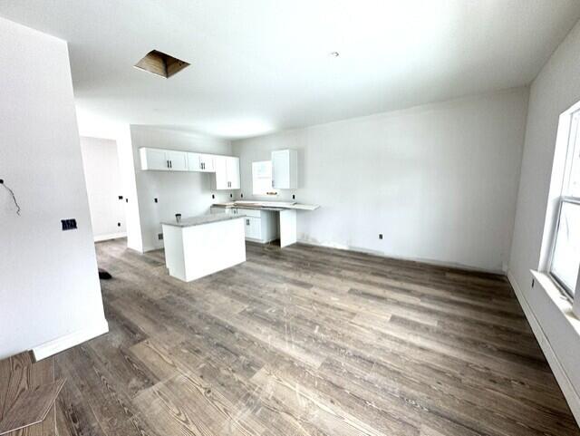 kitchen featuring white cabinetry and dark hardwood / wood-style floors