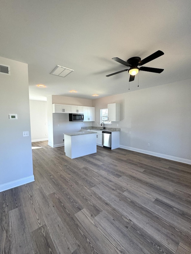 kitchen with appliances with stainless steel finishes, dark wood-style flooring, visible vents, and white cabinetry