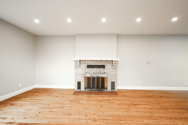 unfurnished living room featuring a fireplace and light wood-type flooring