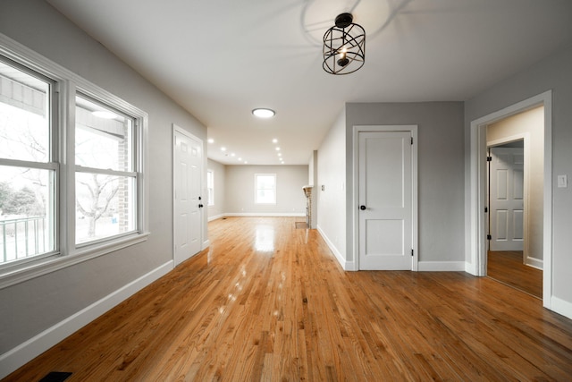 hallway with light hardwood / wood-style floors