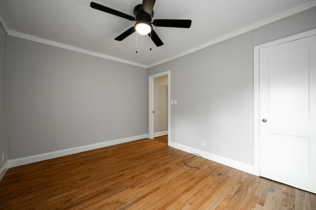 empty room with hardwood / wood-style flooring, ceiling fan, and crown molding