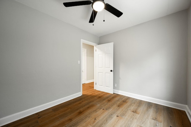 spare room with light hardwood / wood-style flooring and ceiling fan