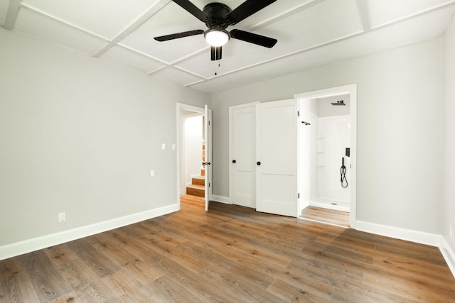 unfurnished bedroom with ceiling fan and hardwood / wood-style floors