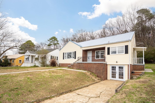 view of front of property with a front lawn and french doors