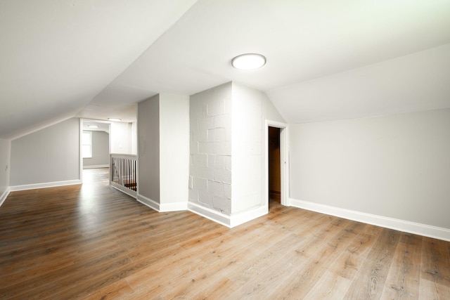 bonus room with wood-type flooring and lofted ceiling