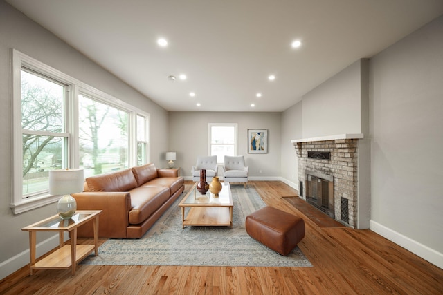 living room with a fireplace and light hardwood / wood-style flooring