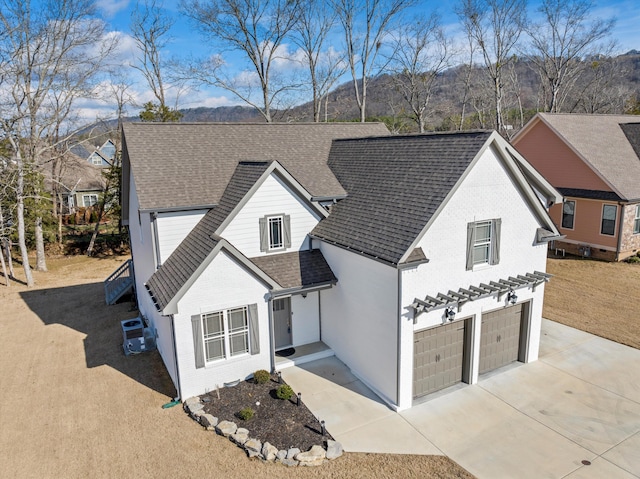 view of front of house with central AC unit and a garage