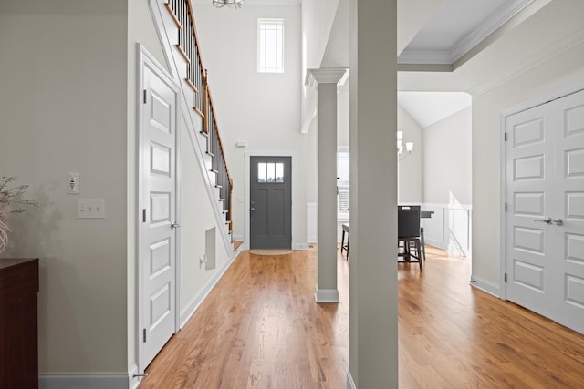 foyer featuring a wealth of natural light, hardwood / wood-style floors, and ornamental molding