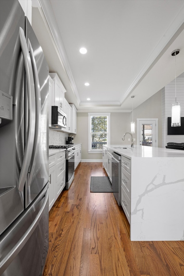 kitchen with backsplash, white cabinetry, sink, and appliances with stainless steel finishes