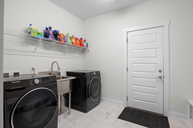 laundry area with independent washer and dryer and sink