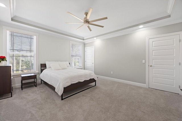 bedroom featuring a raised ceiling, ceiling fan, and light carpet