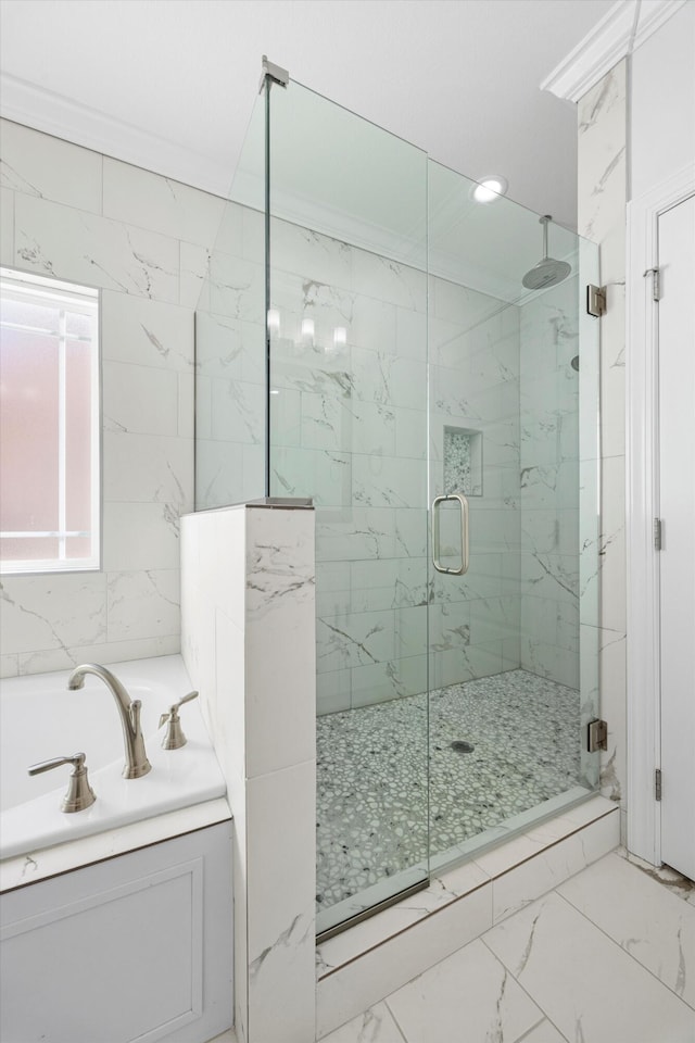 bathroom featuring separate shower and tub and crown molding