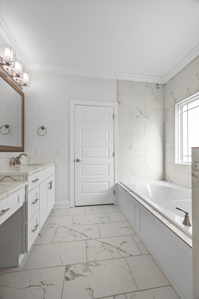 bathroom with a bath, vanity, and ornamental molding