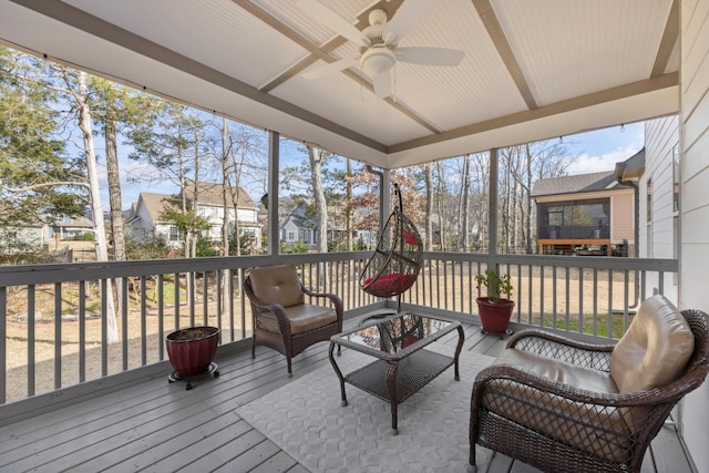 sunroom / solarium featuring ceiling fan and plenty of natural light