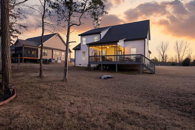 back house at dusk with a wooden deck