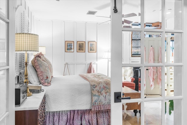 bedroom with ceiling fan and floor to ceiling windows