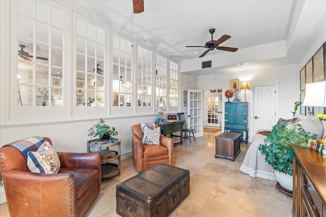 living room featuring ceiling fan and french doors