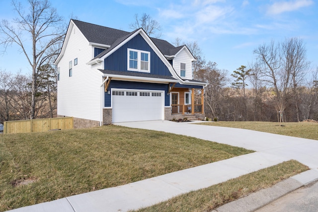 craftsman house with a front yard, a garage, and covered porch