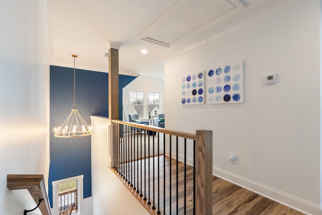 hall featuring hardwood / wood-style floors and a notable chandelier