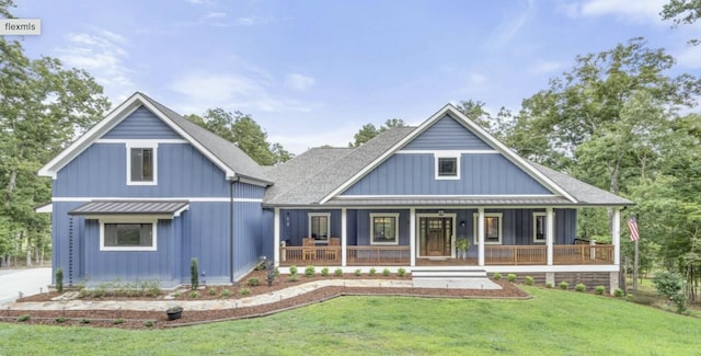 view of front of property with covered porch and a front yard