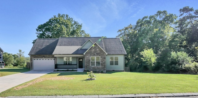 view of front of home featuring a porch, a garage, and a front yard