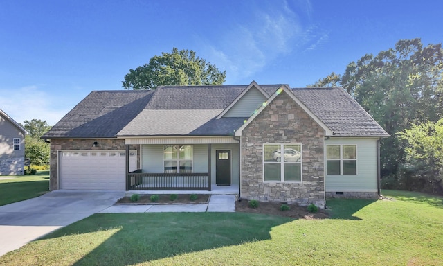 view of front of house featuring a porch, a garage, and a front lawn