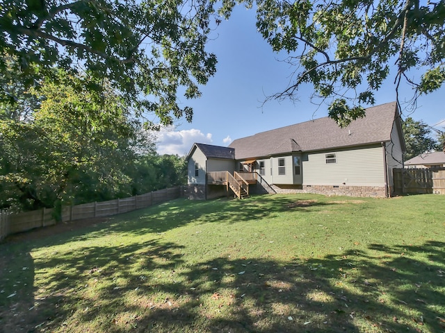 back of property featuring a yard and a deck