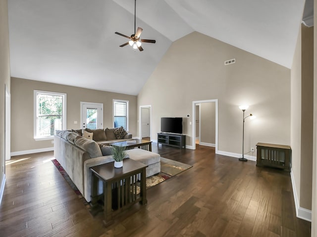 living room featuring dark hardwood / wood-style floors, ceiling fan, and high vaulted ceiling