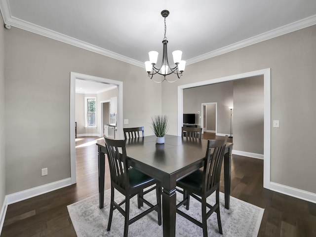 dining space with dark wood-type flooring, a chandelier, and ornamental molding