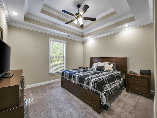 bedroom with a raised ceiling, ceiling fan, light colored carpet, and ornamental molding