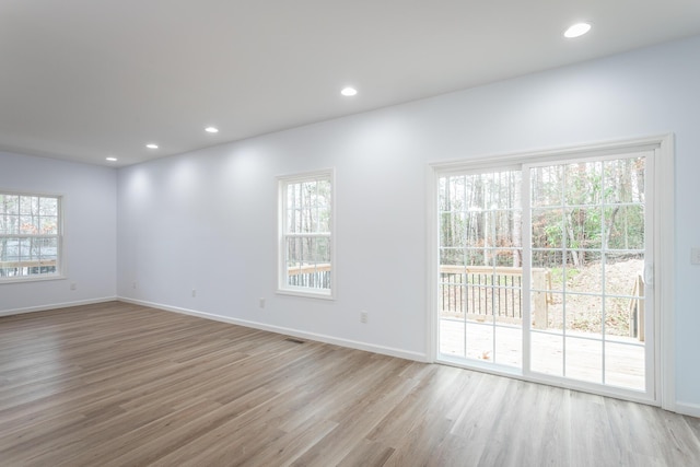 spare room with a healthy amount of sunlight and light wood-type flooring